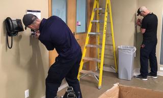 Maintenance Technicians Jeff Vogt and Matt Litzenberger carrying out essential electrical work at UBCO