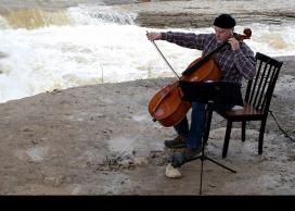 Eric Wilson playing cello on the river