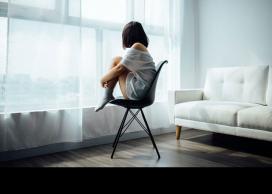 Girl sitting alone in room