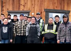 BC Institute of Technology instructor Marcel Studer (centre) and an all-Heiltsuk construction crew in front of one of the Nation’s new Tiny Homes.